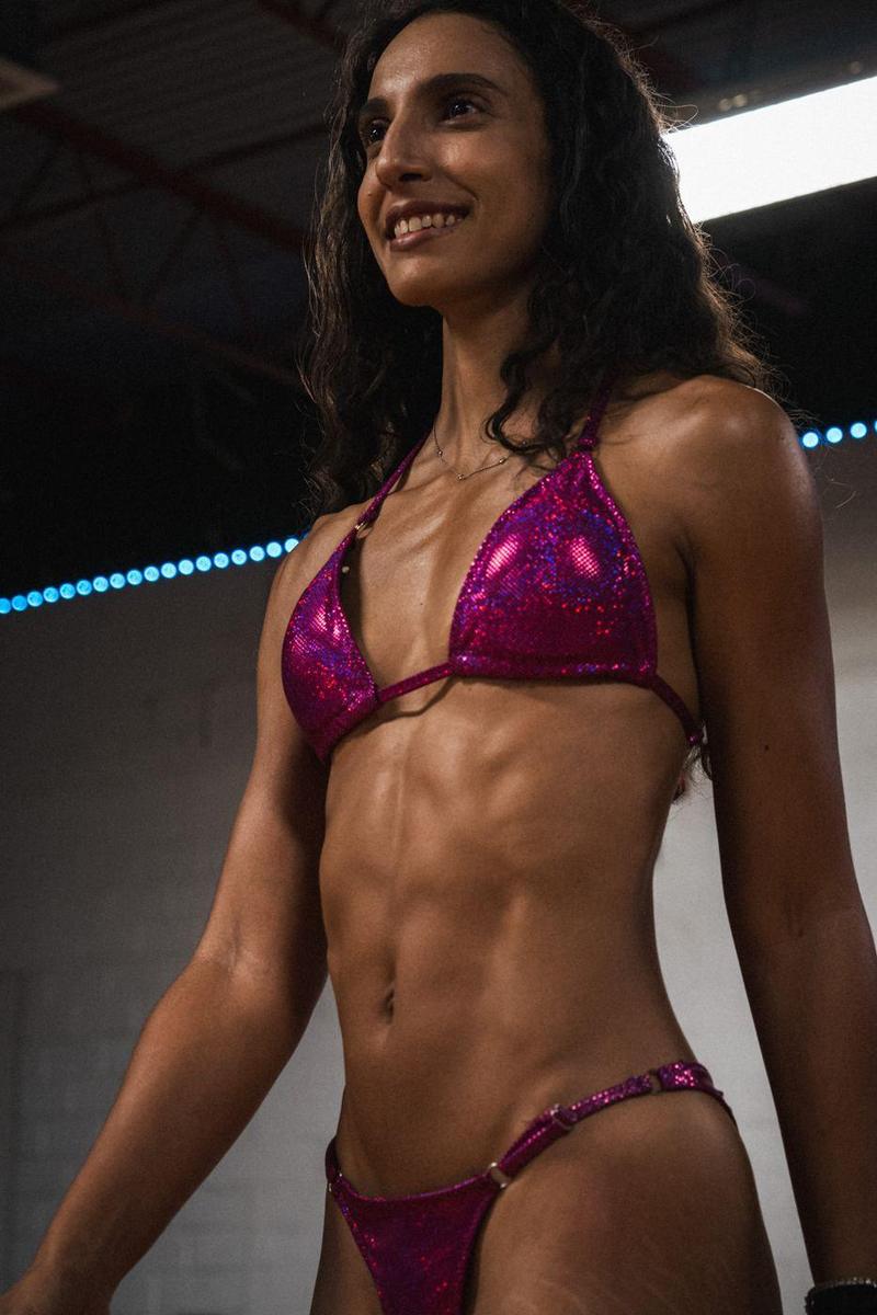 Bikini competitor smiling under the lights